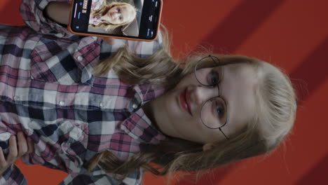 girl holding up phone showing selfie