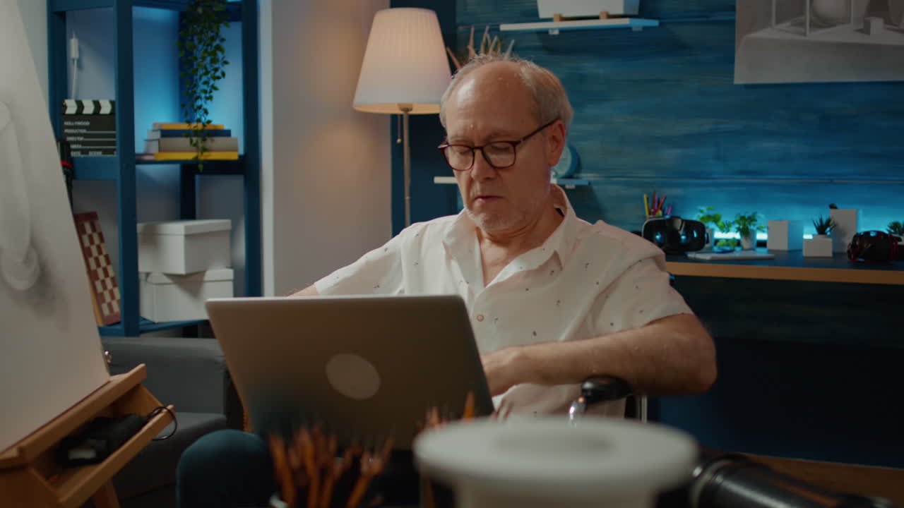 Senior adult in wheelchair using laptop to find artistic inspiration