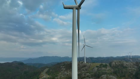 norwegian wind turbines produce clean power in a beautiful coastal setting.