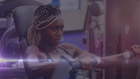 Animation-of-mixed-race-woman-exercising-using-equipment-with-white-light-moving-in-the-foreground