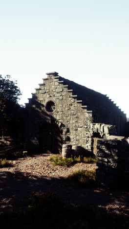 a stone building with an archway and a doorway