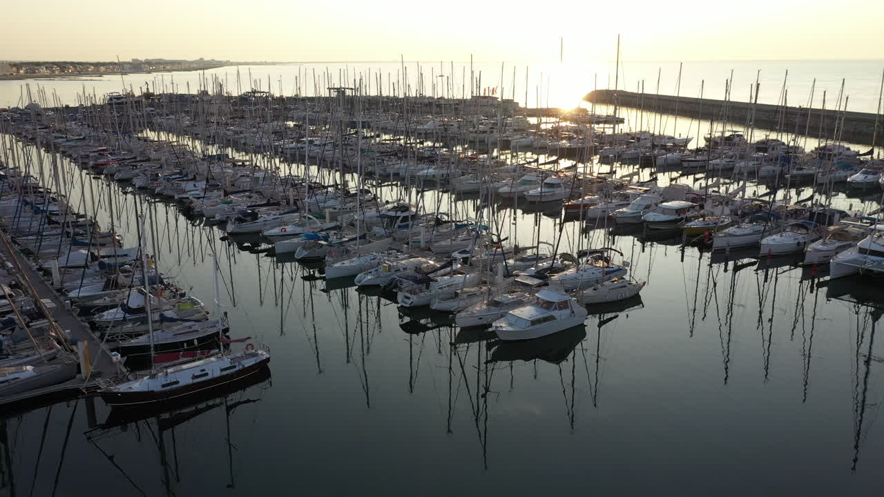 Sunrise over boats in an harbor Palavas les Flots France glassy water docked