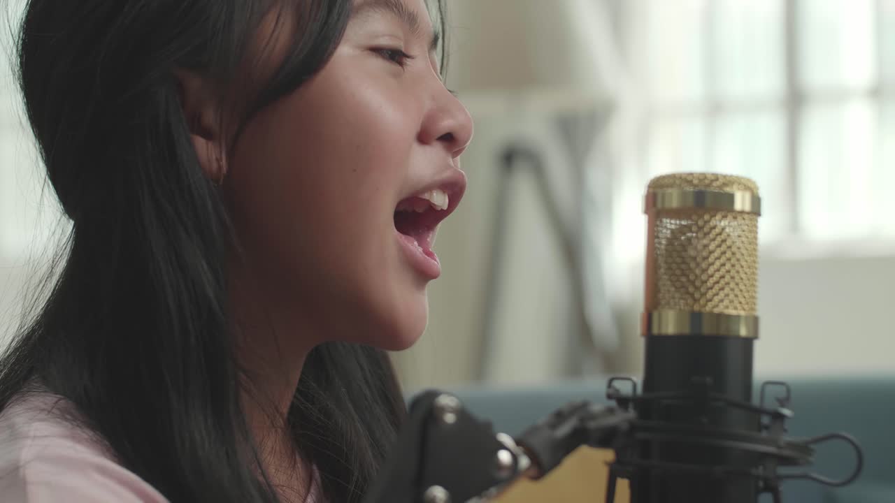 어린 소녀 가 마이크 로 노래 하고 있다