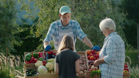 An-elderly-woman-and-her-granddaughter-buy-vegetables-together-at-a-farmers-market