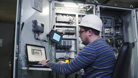 industrial technician working on control panel