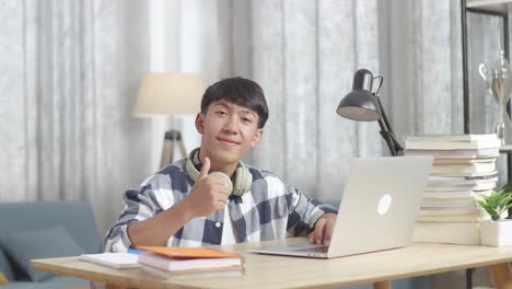 teenager studying at home with laptop