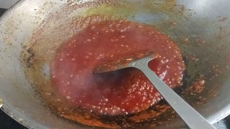 sambal tumis or stir-fried chilli paste is a versatile malay and indonesian condiment in the hot pan which is used for cooking spicy dishes such as added with prawns, egg and stinky beans.