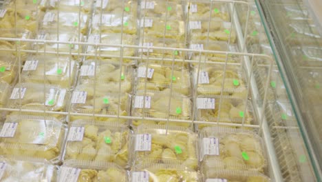 woman shopping for frozen food at the grocery store