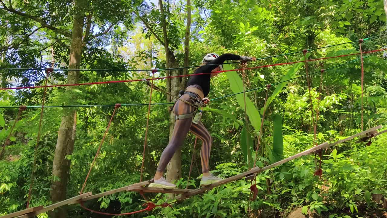 Woman Ziplining Through a Jungle Canopy