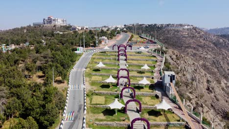 Aerial-view-overlooking-details-of-the-Raghadan-Forest-Park,-in-Saudi-Arabia---rising,-pull-back,-drone-shot