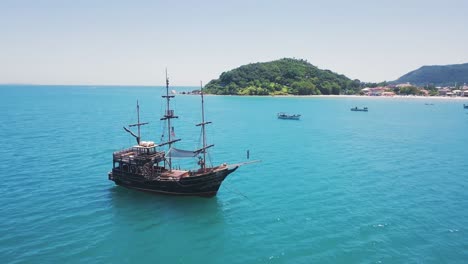 4k aerial drone circling pirate boat on paradise island