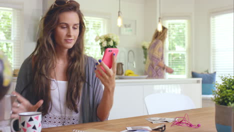 Girl-friends-planning-their-road-trip-using-smart-phone-at-home