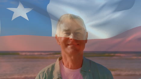 animation of flag of chile over happy senior caucasian man on beach