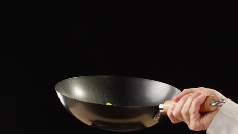 chef cooking with a wok
