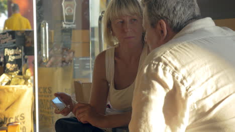 Senior-couple-with-smart-phone-in-cafe