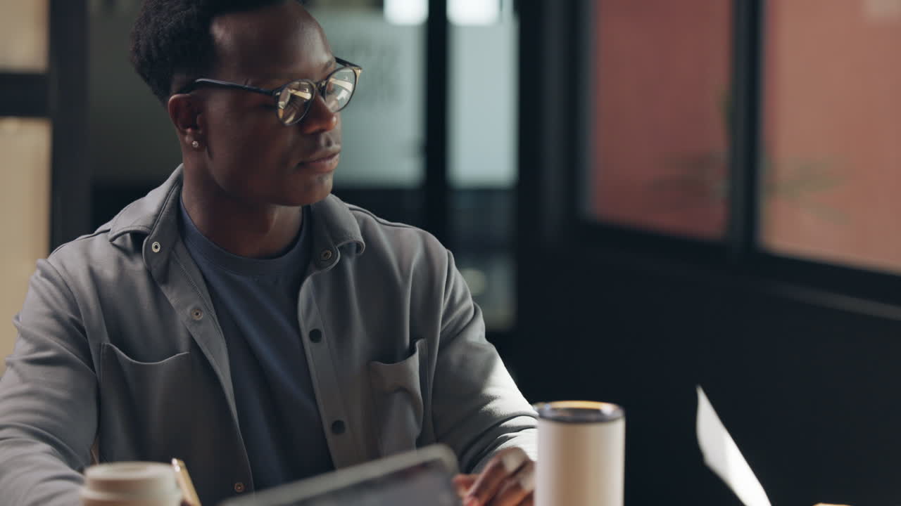 Man with glasses working in office