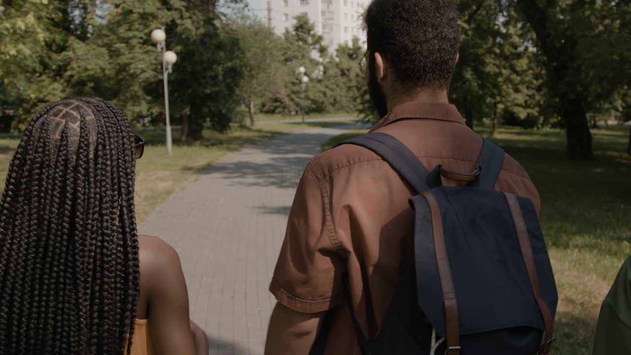 Diverse friends walking and talking in a park