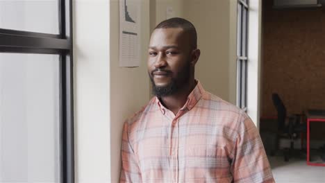 portrait of happy african american casual businesswoman in office, slow motion