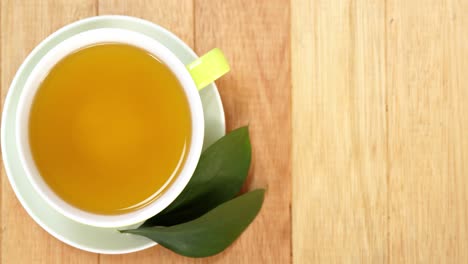 Close-up-of-tea-cup-with-saucer-and-tea-leaves