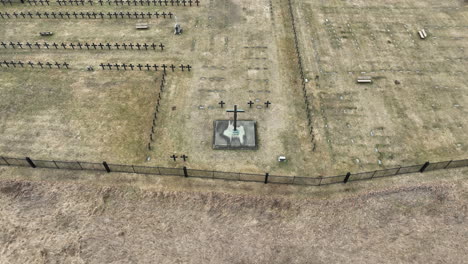 Aerial-footage-of-christian-cemetery-in-late-winter-showing-fences,-gravestones,-and-crosses