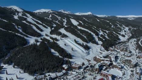 drone aerial copper mountain birds eye view winter ski snowboard resort ikon pass parking lot lodging hotels colorado early morning sunlight fresh snow ski lift crowd cinematic backward pan motion 4k