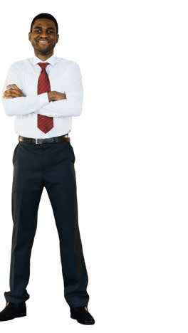 portrait of smiling businessman standing with arms crossed