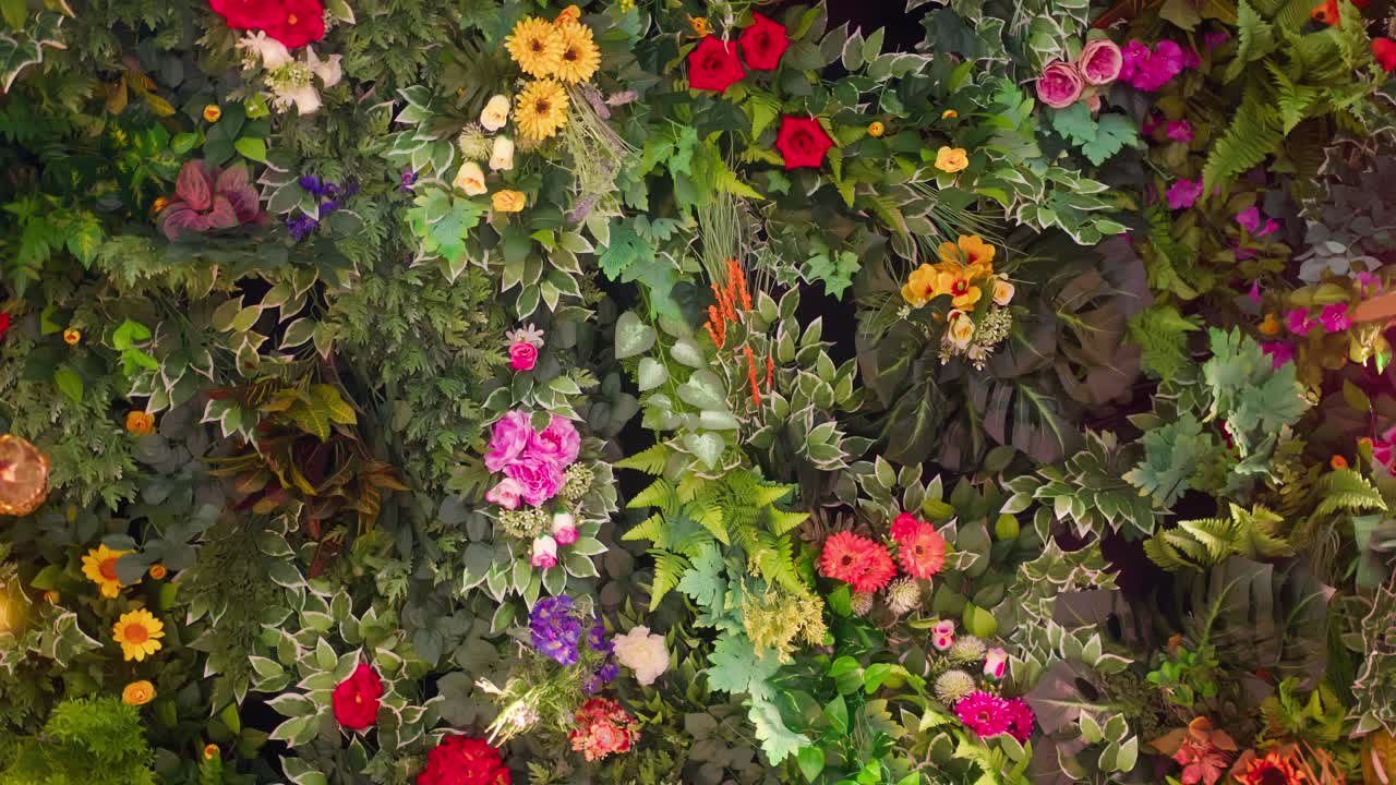 Leftward spinning shot of floral ceiling with colorful flowers and plants in Taormina, Sicily, Italy (Sicilia, Italia)