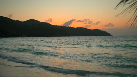 Hermosa-Playa-En-Seychelles-Al-Atardecer-Con-El-Océano-Y-Las-Montañas-A-La-Vista