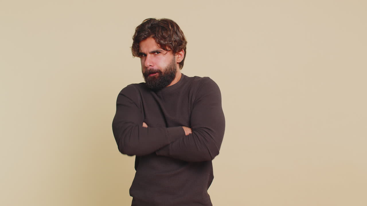 Lebanese young man screams yell from stress tension problems feels horror against beige background