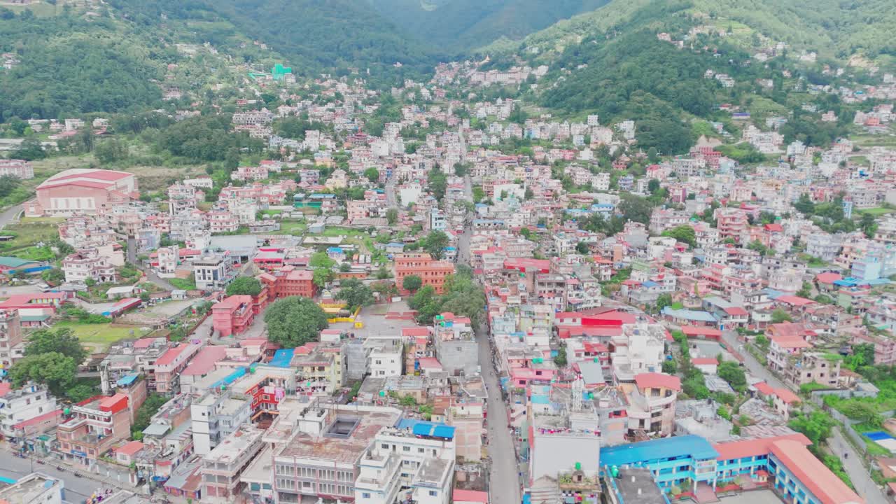 Aerial drone footage of Budhanilkantha in Kathmandu Valley, Nepal, showcasing city settlements, green hills, and scenic mountain landscapes from above