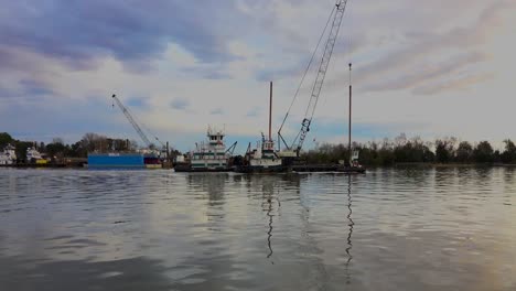 tug and dredging equipment floating down the savanna river