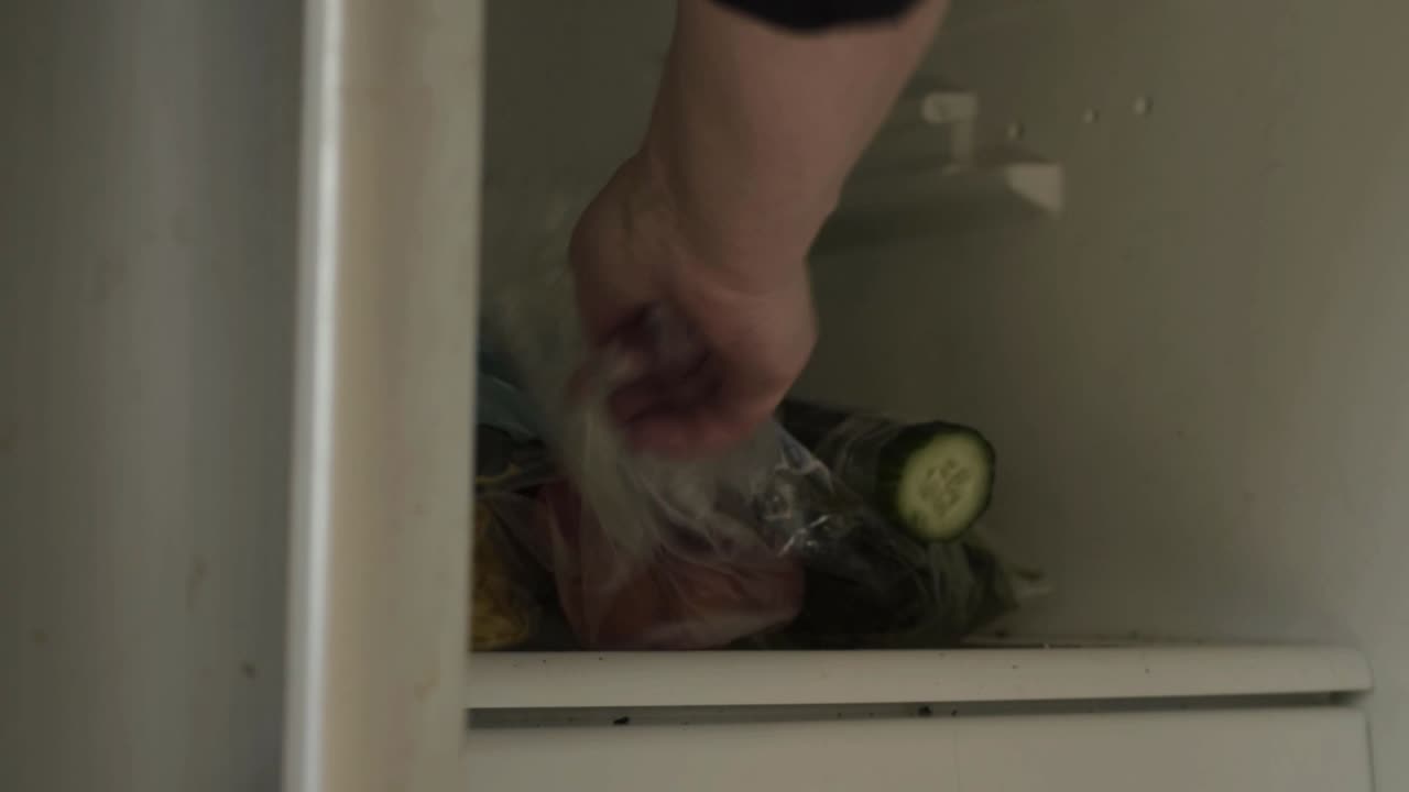 Hands open refrigerator door to get food close up shot