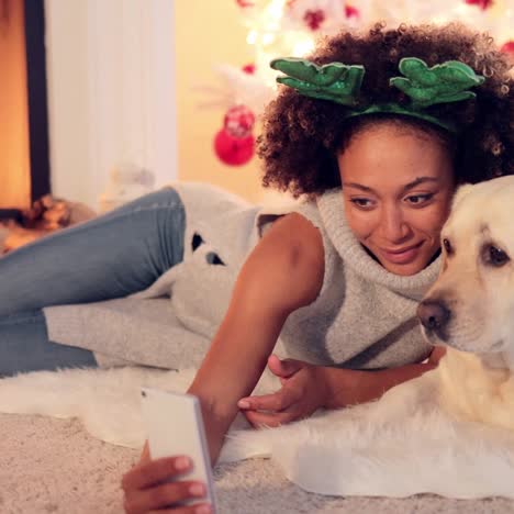 cute young woman taking a selfie with her dog