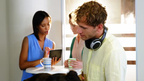 businesspeople discussing over digital tablet