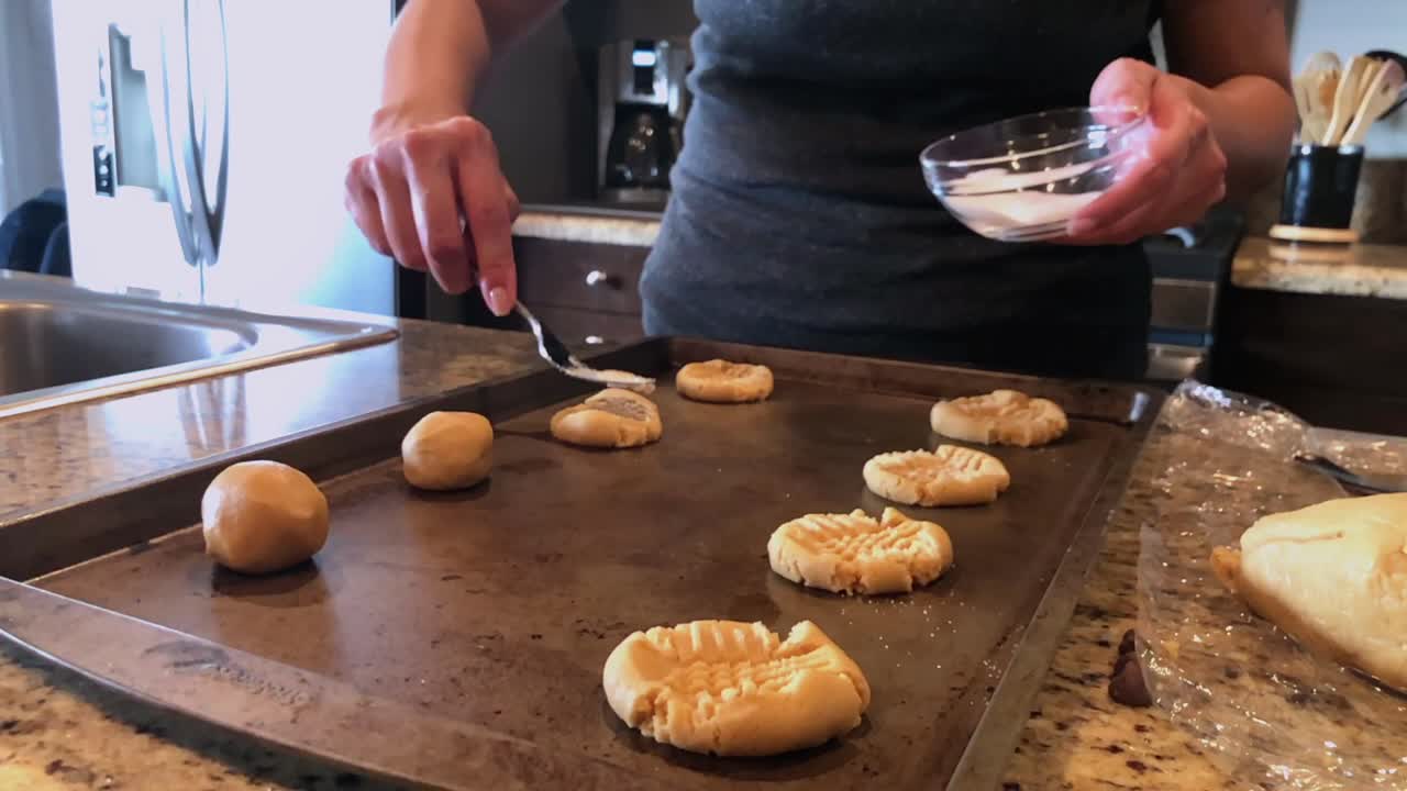 Pull back, making peanut butter cookies, in kitchen, Los Angeles