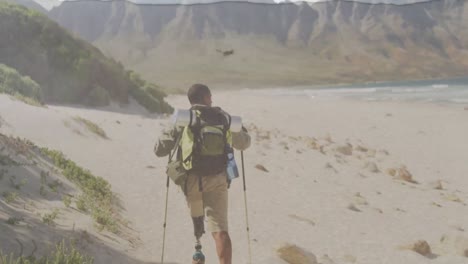 animation of sea over disabled african american male hiker