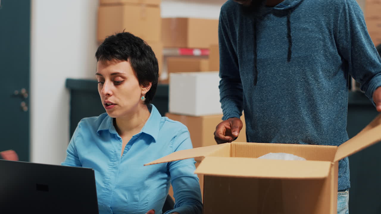 People packing items into cardboard boxes