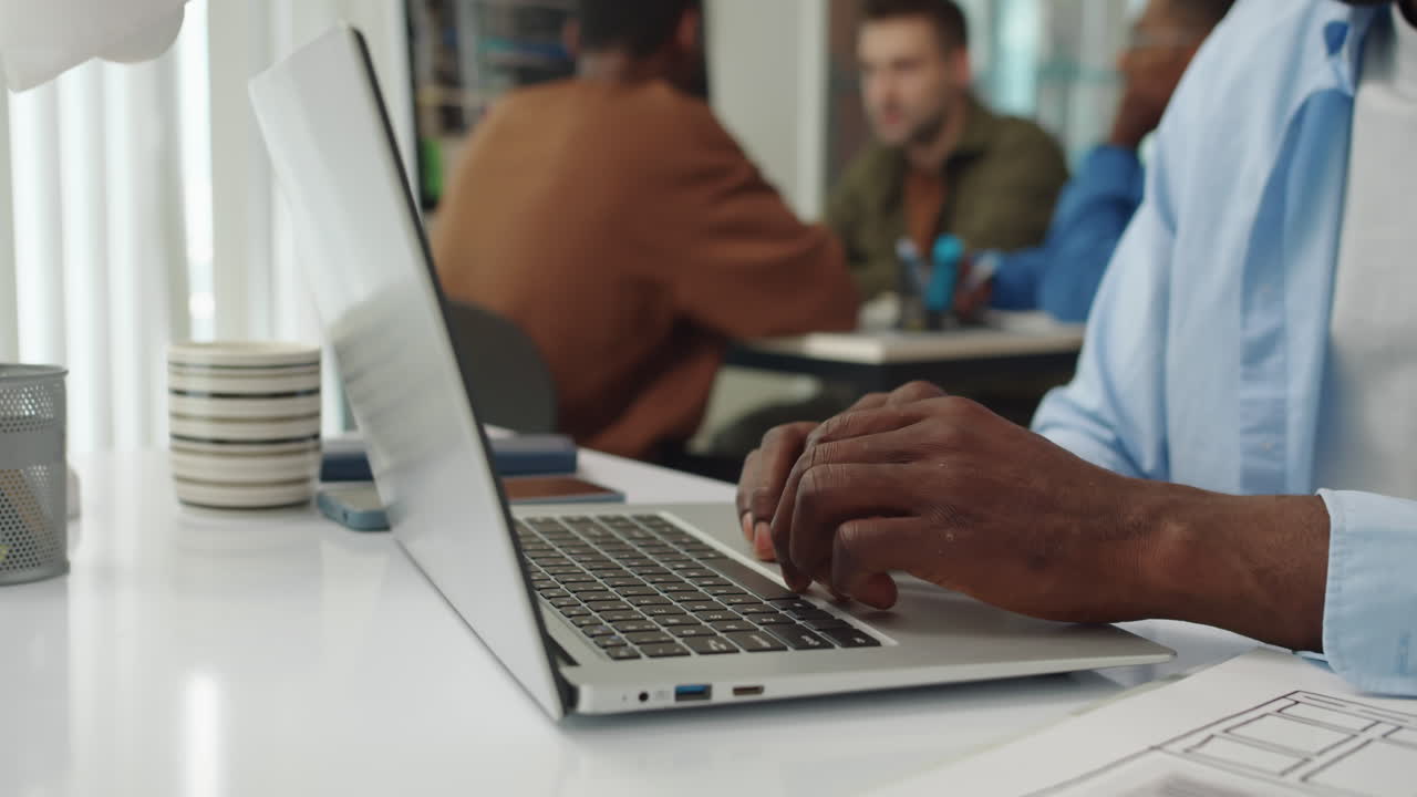 Hands of Programmer Typing Code on Laptop at Office Desk