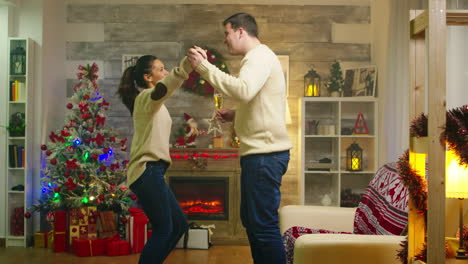 cheerful young couple dancing in living room