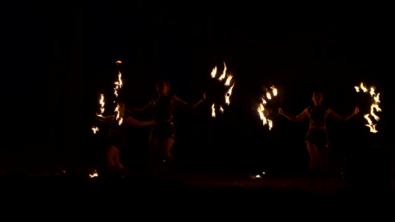 grupo de malabaristas de fuego. gente escupir fuego en una noche oscura al aire libre actuación