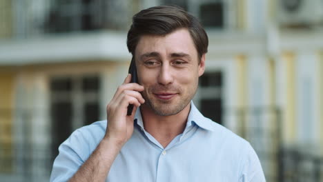 portrait man having phone talk outdoor. man talking on phone in shirt outdoor