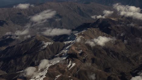 Aerial-view-from-airplane-of-snow-covered-Iran-mountain-range-landscape-in-middle-east-desert-area