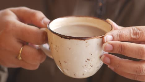 person holding a cup of hot drink