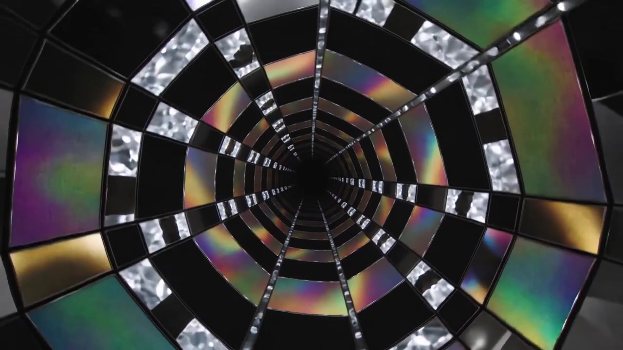 LEDs brightening, banded panel tunnel rotating forward inside installation, drawing eye inward