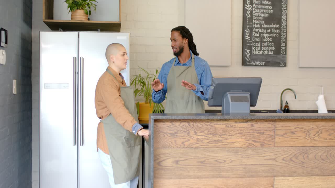 Diverse coworkers leaning and nodding after greeting, discussing day's specials at cafe counter