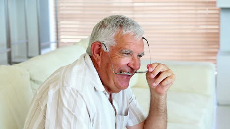 Happy-senior-man-sitting-on-the-couch