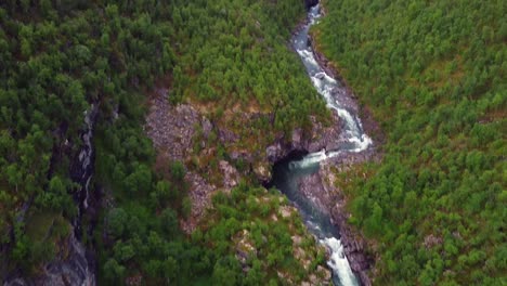 Ivgojohka-river-winding-stream-alongside-green-hillsides,-Northern-Norway