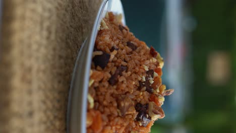 a mexican red rice plate on a table, close up shot