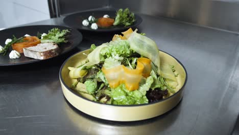 freshly prepared salad and appetizers on a professional restaurant kitchen counter