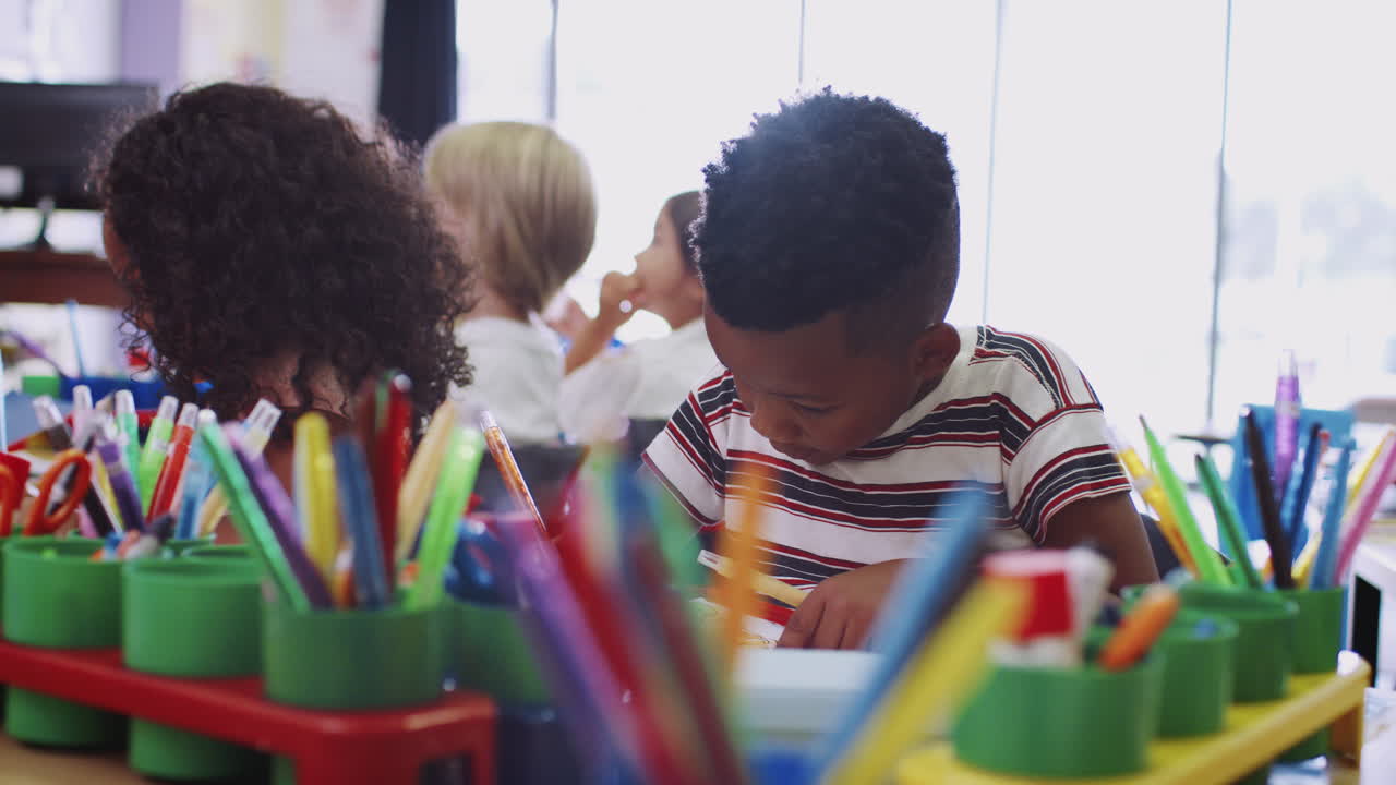 Group Of Elementary School Pupils Working At Desks Together